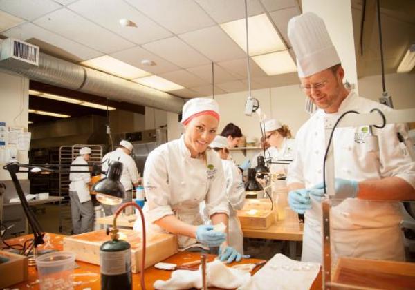 Baking and pastry arts students working together in a kitchen